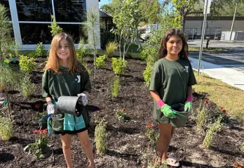 Two students celebrate Earth Day at the Greater Palm Harbor YMCA.