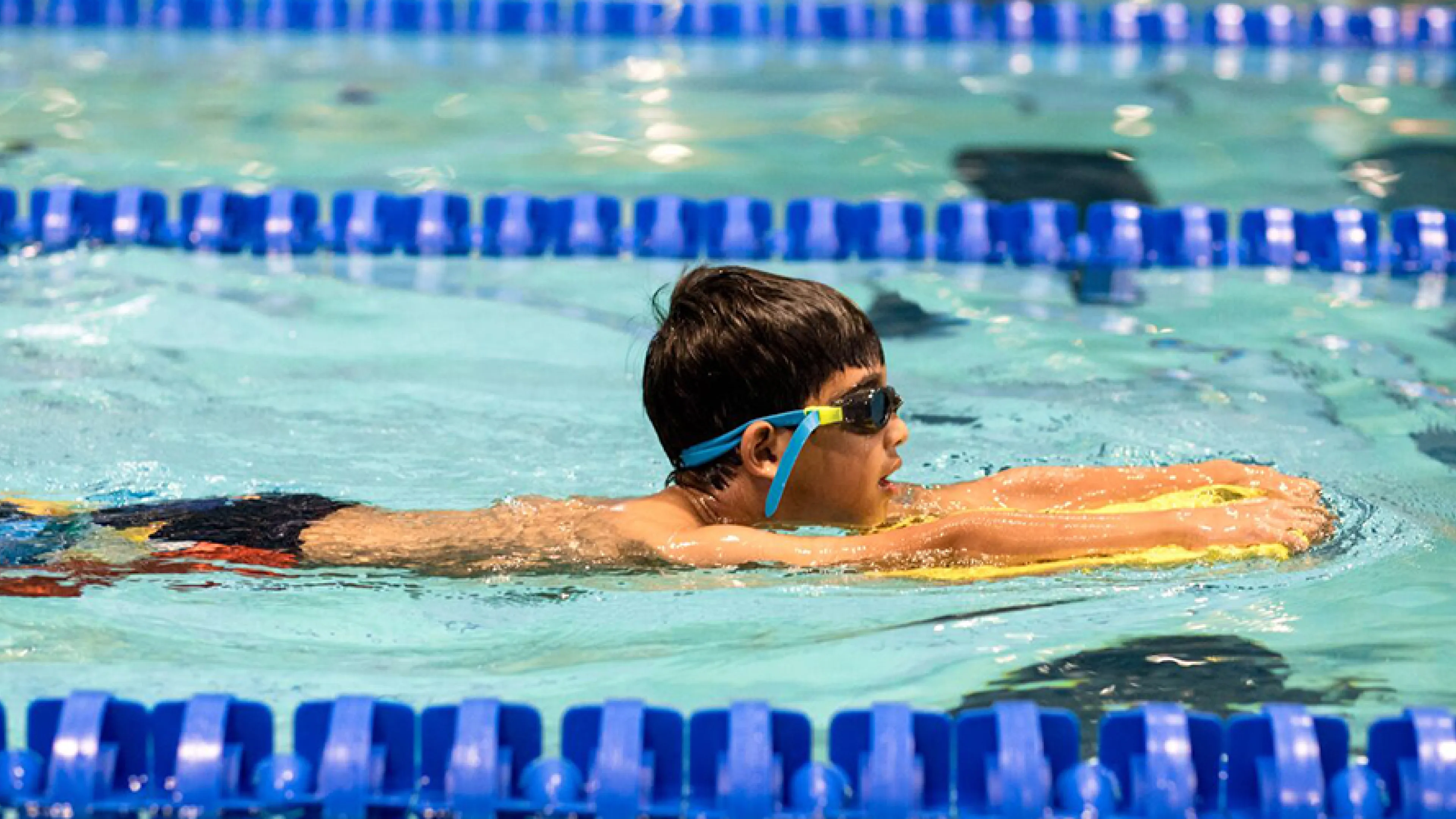 boy using a mini board for safety arond water