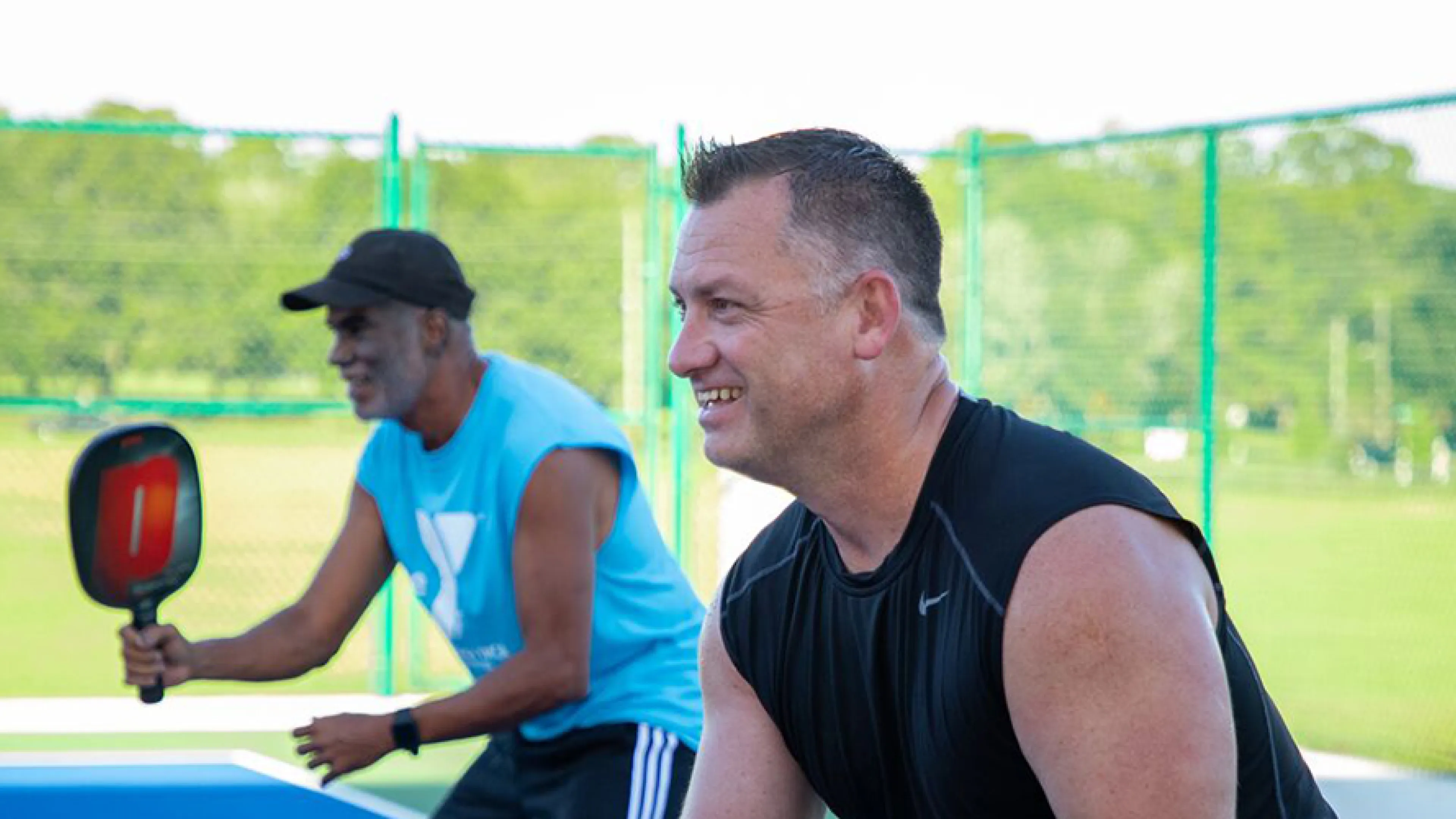 two man pickleball team waiting for service