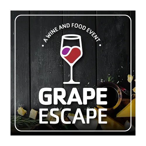 Graphic with white text that reads A Wine and Food Event, a wine glass white outline with red and purple fill half the glass. The largest words GRAPE ESCAPE in the bottom third. The background is an image of a dark wood/black table with cheese, rosemary at the bottom right.