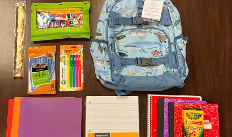 backpack and school supplies laid flat on the table