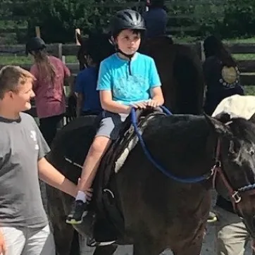 camp coast camper liam on a horse