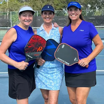 Kat Orr, Kelly Westbrook and Robbie McKee pose for a photo at the John Geigle YMCA pickleball courts. 